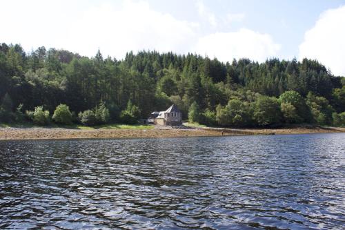 
a boat floating on top of a body of water at The Boathouse in Glencoe
