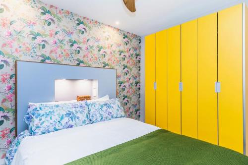 a bedroom with brightly colored cabinets and a bed at Brand new and cozy studio: Bairro Alto/ Chiado in Lisbon