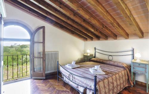 a bedroom with a bed and a large window at Villa Doveri Ceppeto in Forcoli