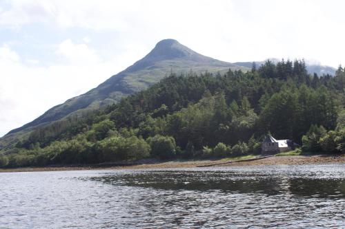 
a large body of water surrounded by trees at The Boathouse in Glencoe
