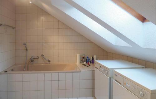 a bathroom with a bath tub and a sink at Beautiful Apartment In Todtmoos With 2 Bedrooms And Wifi in Todtmoos