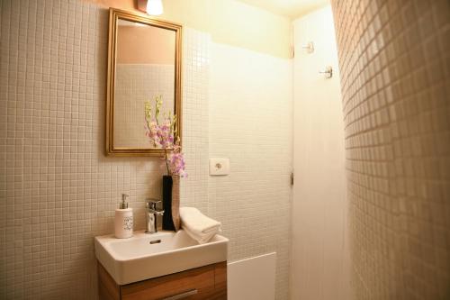 a bathroom with a sink and a mirror at Iatis View Collection in Imerovigli