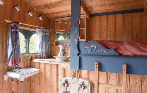 a bathroom with a bed and a sink in a room at 1 Bedroom Awesome Home In Tvedestrand in Tvedestrand