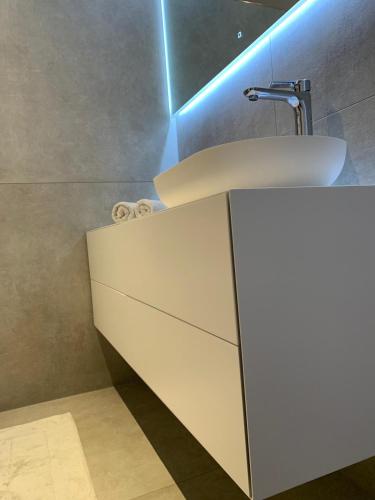 a bathroom with a sink and a white cabinet at Appartement Schladming Neu in Schladming