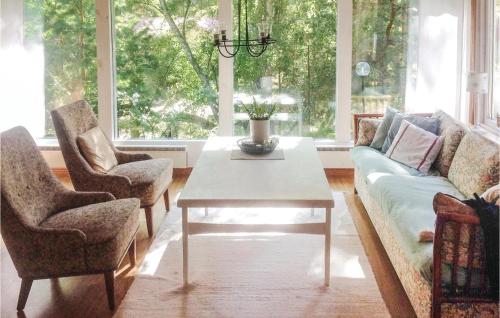 a living room with a couch and a table at Amazing Home In Yngsj With 2 Bedrooms in Yngsjö