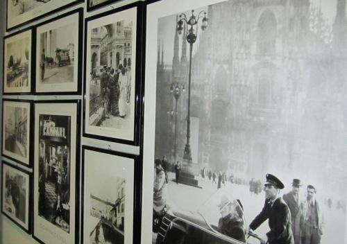 a group of pictures on a wall in a museum at eco Hotel Milano & BioRiso Restaurant in Milan