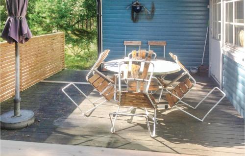 a patio with a table and chairs on a porch at Amazing Home In Yngsj With 2 Bedrooms in Yngsjö