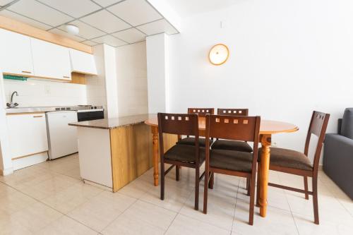 a kitchen with a table and chairs in a room at Catalonia Gardens in Salou