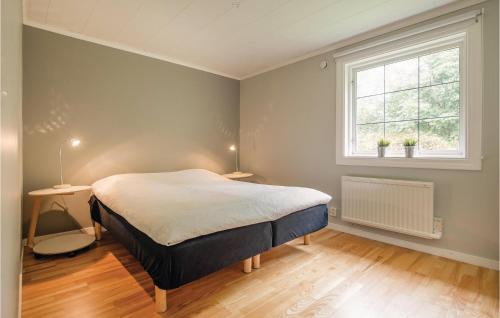 a bedroom with a bed and a window at Holiday Home Hult Gunnarp Ätran in Bälshult