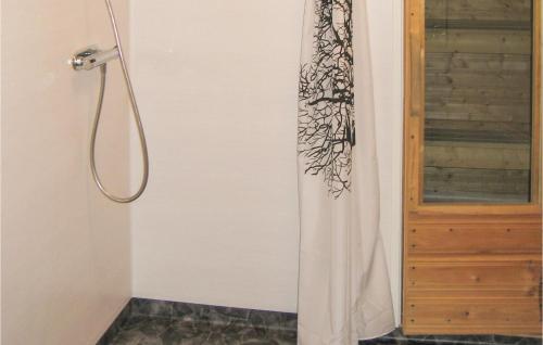 a shower with a shower curtain next to a door at Nice Home In Transtrand With Sauna And Wifi in Transtrand