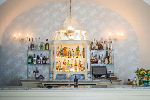 a bar with a lot of bottles of alcohol at Hotel Marina Riviera in Amalfi