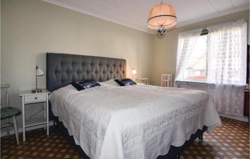 a bedroom with a large bed and a window at Awesome Home In Sjtorp With Wifi in Sjötorp
