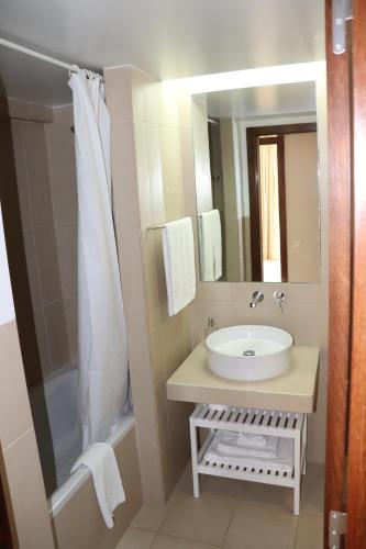 a bathroom with a sink and a mirror at Salgados Beach&Golf - Praia dos Salgados in Albufeira