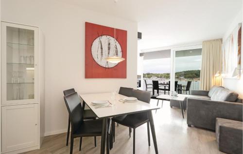 a dining room and living room with a table and chairs at Priwallpromenade 3, Whg 2 in Priwall