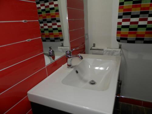 a bathroom with a white sink and a mirror at B&B Villa del Sole Relais in Agrigento