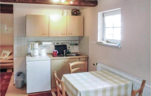 a small kitchen with a table and a sink at Lovely Home In Blankenburg With Wifi in Blankenburg
