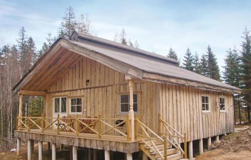 a wooden cabin in the middle of a forest at 4 Bedroom Lovely Home In Mellerud in Mellerud