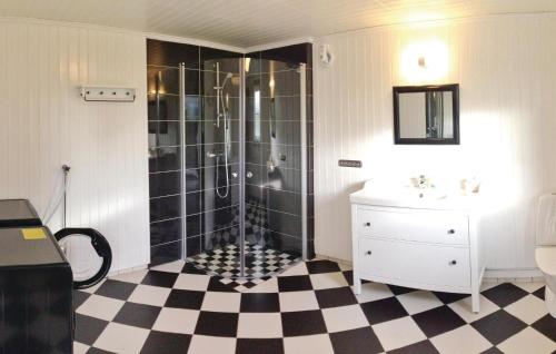 a bathroom with a shower and a checkered floor at Cozy Home In Skillingaryd With Wifi in Nydala