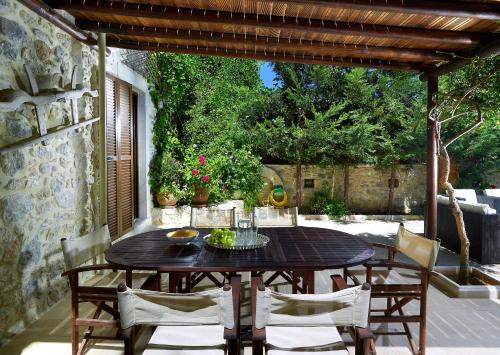 a wooden table and chairs on a patio at Agrielia Villa in Episkopi (Heraklion)