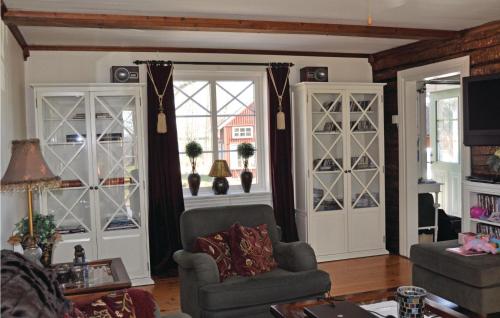 a living room with a chair and a window at Lovely Home In Mellerud With Kitchen in Mellerud