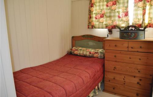 a small bedroom with a bed and a dresser at Lovely Home In Mellerud With Kitchen in Mellerud