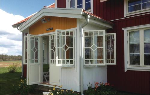 a screened in porch on the side of a house at Cozy Home In Skillingaryd With Wifi in Nydala