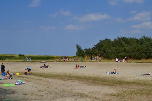 a group of people laying on a beach at Haus Schimmelreiter in Greetsiel