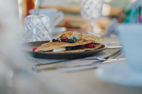a plate of food sitting on a table at Panorama Glamping Visole in Slovenska Bistrica