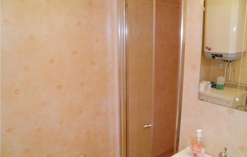 a bathroom with a wooden cabinet next to a sink at Gorgeous Home In Mollsund With Kitchen in Mollösund