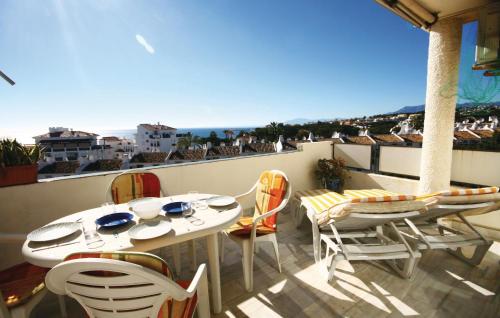 a patio with a table and chairs on a balcony at Beautiful Apartment In Calahonda in La Cala de Mijas
