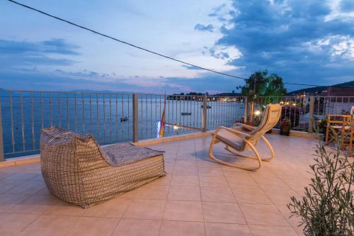 a balcony with two chairs and a view of the water at Gatzeas Blue in Kato Gatzea