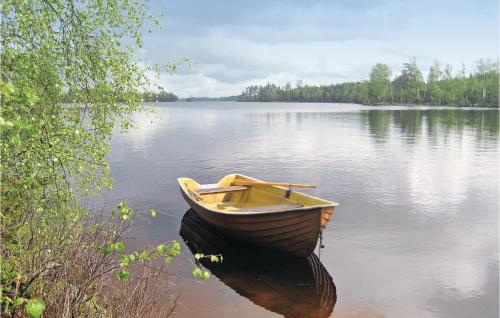 a boat sitting in the water on a lake at Two-Bedroom Holiday Home In Langaryd in Långaryd