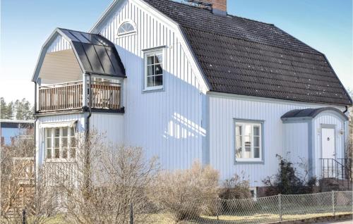 a white house with a black roof at Stunning Home In Hultsfred With Sauna in Hultsfred