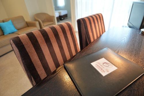 a table and chairs with a laptop on top of it at Gladstone City Central Apartment Hotel Official in Gladstone