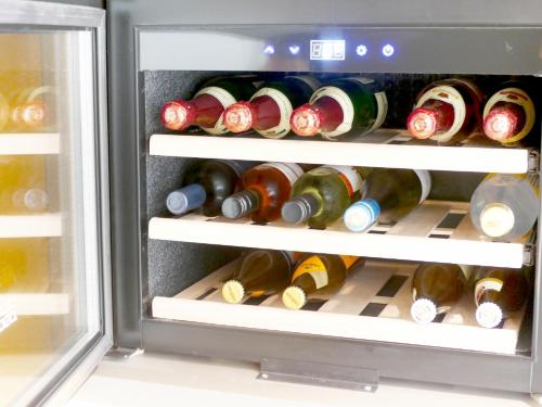 an open refrigerator filled with lots of wine bottles at Großes Apartment im Zentrum von Dresden, 2 Schlafzimmer, 2 Bäder, Balkon in Dresden