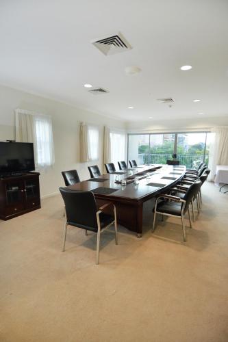a large conference room with a large table and chairs at Gladstone City Central Apartment Hotel Official in Gladstone