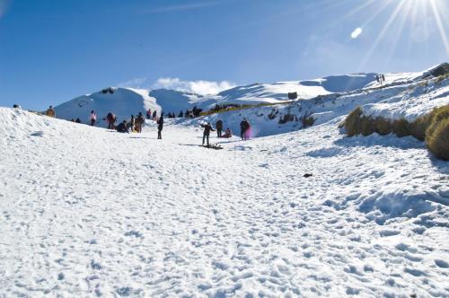 a group of people skiing down a snow covered slope at Formosa Vacation Village Homestay in Renai
