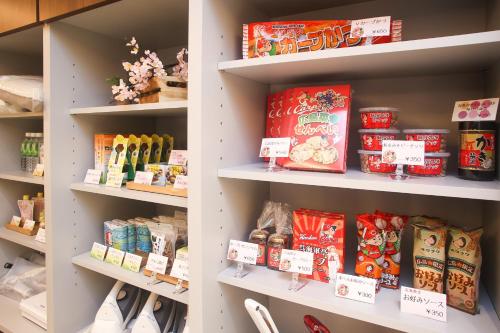 a store shelf with food and other food items at Hotel Kuretakeso Hiroshima Otemachi in Hiroshima