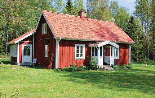 a red house with a red roof on a yard at Holiday Home Knihult Häradsbäck in Knihult