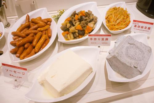 a table with plates of food on a counter at Hotel Kuretakeso Hiroshima Otemachi in Hiroshima