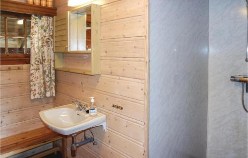 a bathroom with a sink and a wooden wall at Amazing Home In Hemsedal With 3 Bedrooms in Hemsedal