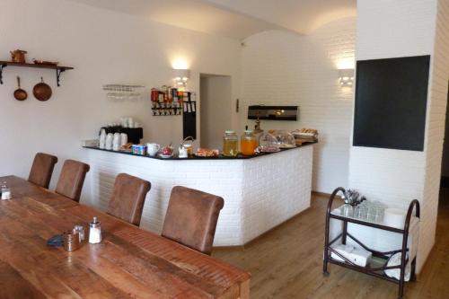 a dining room with a table and a bar at Penzion Stranny in Stranný