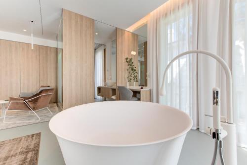 a bathroom with a large white tub in a room at Villa Italia in Cesenatico