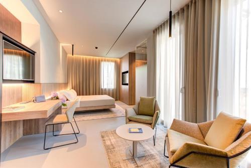 a hotel room with a bed and a living room at Villa Italia in Cesenatico
