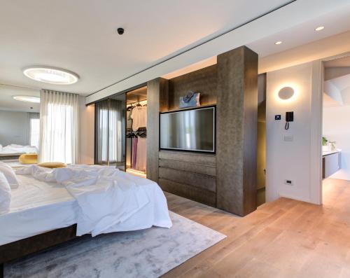 a bedroom with a large bed and a flat screen tv at Villa Italia in Cesenatico