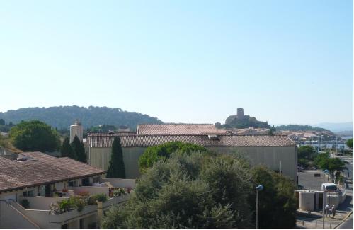 a view of a city with buildings and trees at Hôtel Port Beach in Gruissan