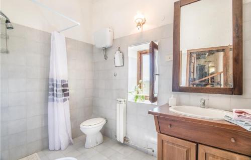 a bathroom with a toilet and a sink and a mirror at Casale Petrucci in Vacone