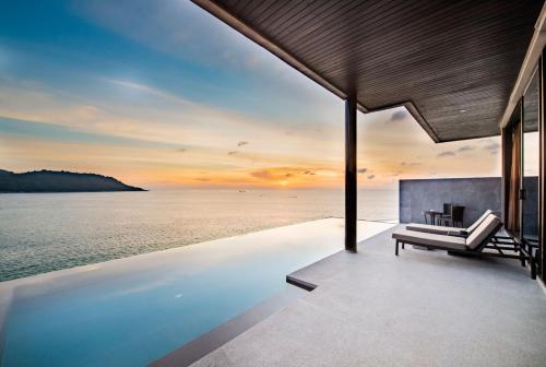 a view of the ocean from a house with a swimming pool at Impiana Private Villas Kata Noi in Kata Beach