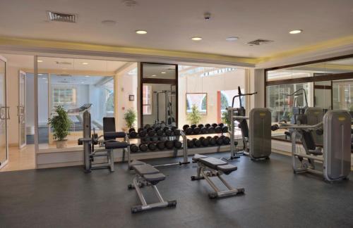 a gym with treadmills and exercise equipment in a building at Villa Rosa Kempinski in Nairobi