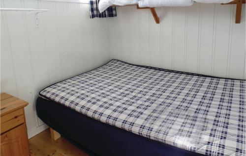 A bed or beds in a room at Strandstua